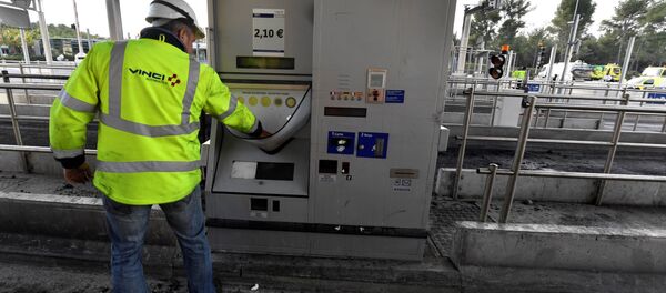 A worker of French construction group Vinci looks at a damaged payment booth a day after the highway toll was set on fire on December 18, 2018 in Bandol, near Marseille - Sputnik Afrique