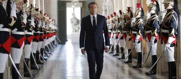 French President Emmanuel Macron walks through the Galerie des Bustes (Busts Gallery) to access the Versailles Palace's hemicycle to address both the upper and lower houses of the French parliament at a special session in Versailles, near Paris, Monday, July 9, 2018. - Sputnik Afrique