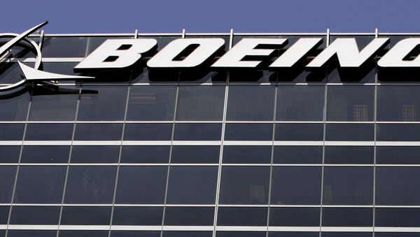 File-In this Wednesday, May 21,2008 file photo, the company logo for The Boeing Co., is displayed in El Segundo, Calif. Boeing Co. say it's cutting 1,100 jobs from its U.S. plants, most of them in Southern California, as it scales back production of its C-17 cargo planes. - Sputnik Afrique