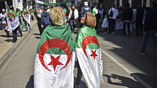 X AFP Photo Document reference 000_1F78O0 SLUG ALGERIA - POLITICS - DEMO Creation date 3/29/2019 Country Algiers, Algeria Credit Ryad KRAMDI / AFP File size/pixels/dpi 69.12 Mb / 6016 x 4016 / 300 dpi Algerian women protesters draped with the national flag march during a demonstration against ailing President Abdelaziz Bouteflika in the capital Algiers on March 29, 2019. Opposition to Bouteflika has been widening since the chief of staff, General Ahmed Gaid Salah on March 26, 2019 invoked Article 102 of the constitution under which a president can be removed if found unfit to rule. Ryad KRAMDI / AFP - Sputnik Afrique