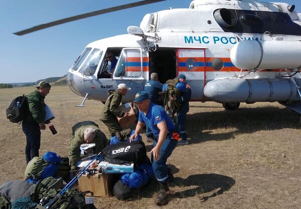 Employés du ministère des Situations d’urgence déchargeant des matériels nécessaires pour éteindre les feux de forêt en Iakoutie. - Sputnik Afrique