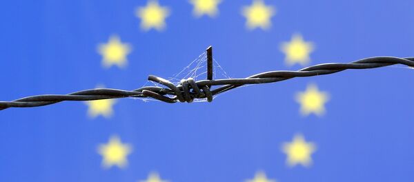 Fil de fer barbelé devant le drapeau de l'Union européenne - Sputnik Afrique