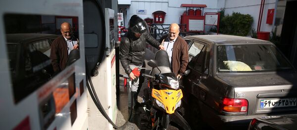 Un homme remplit le réservoir de sa moto dans une station-service, après que le prix de l'essence ait augmenté à Téhéran, en Iran, le 15 novembre 2019. - Sputnik Afrique