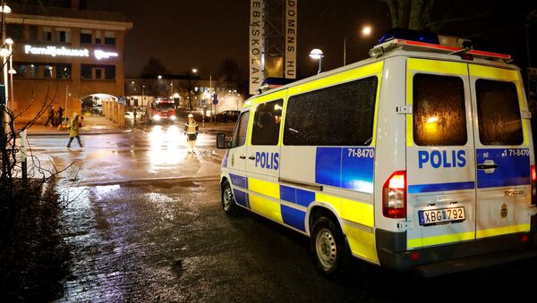 A police car is seen as several cars were set on fire during a riot, according to local media, in Rinkeby suburb, outside Stockholm, Sweden February 20, 2017. - Sputnik Afrique