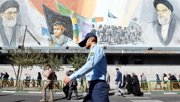 Un militaire iranien passe devant des photos du guide suprême iranien, l'ayatollah Ali Khamenei - Sputnik Afrique