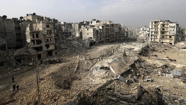 In this picture taken Friday, Jan. 20, 2017 from the balcony of the Abdul-Hamid Khatib home, people walk through mounds of rubble which used to be high rise apartment buildings in the once rebel-held Ansari neighborhood in the eastern Aleppo, Syria - Sputnik Afrique