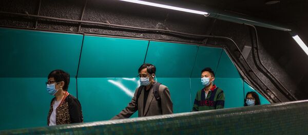 Des personnes portant des masques pour se protéger du coronavirus. Des personnes portant des masques pour se protéger du coronavirus. - Sputnik Afrique