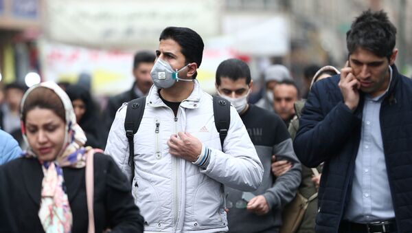 Iranian men wearing protective masks to prevent contracting a coronavirus walk at Grand Bazaar in Tehran, Iran February 20 - Sputnik Afrique