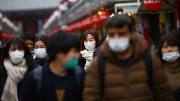 Tourists wearing protective face masks, following an outbreak of the coronavirus disease (COVID-19), visit Asakusa neighbourhood in Tokyo, Japan March 8, 2020 - Sputnik Afrique