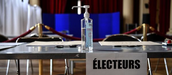 Un flacon de gel hydroalcoolique dans un bureau de vote. - Sputnik Afrique