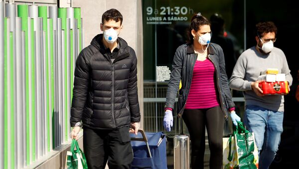 People wearing protective masks walk out of a supermarket, amidst concerns over Spain's coronavirus outbreak in central Madrid - Sputnik Afrique