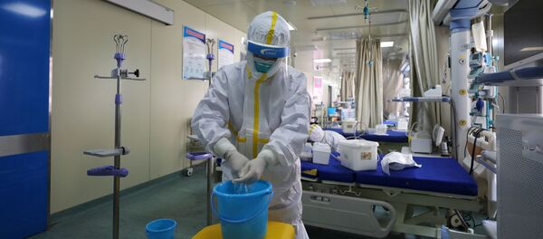 Medical workers in protective suits disinfect an intensive care unit (ICU) ward of Union Jiangbei Hospital in Wuhan, the epicentre of the novel coronavirus outbreak, Hubei province, China March 12, 2020. Picture taken March 12, 2020 - Sputnik Afrique