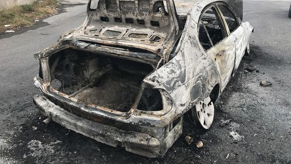 Une voiture incendiée - Sputnik Afrique