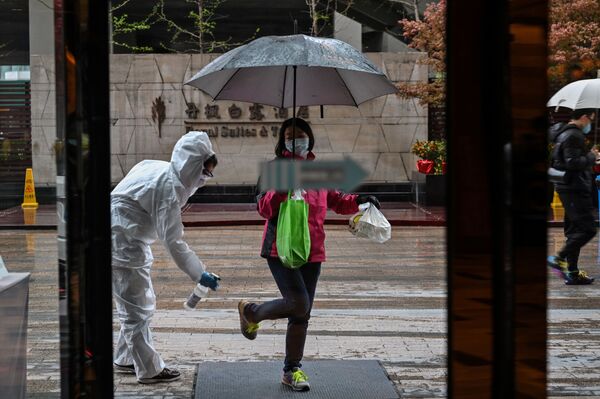 Un employé d'hôtel pendant la désinfection à Wuhan, en Chine - Sputnik Afrique
