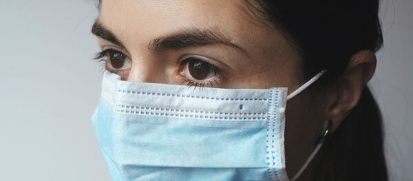 Une femme au masque - Sputnik Afrique